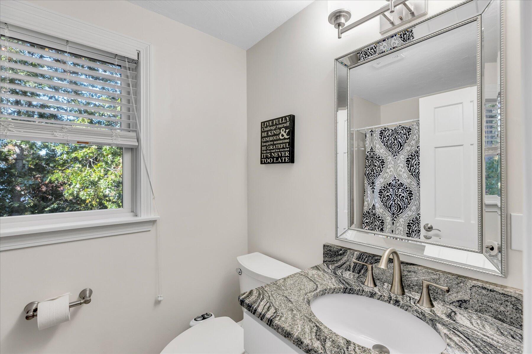 14 Ryder Road North Falmouth, MA 02556 - Photo 54 of 85 a bathroom with a granite countertop sink mirror vanity and toilet