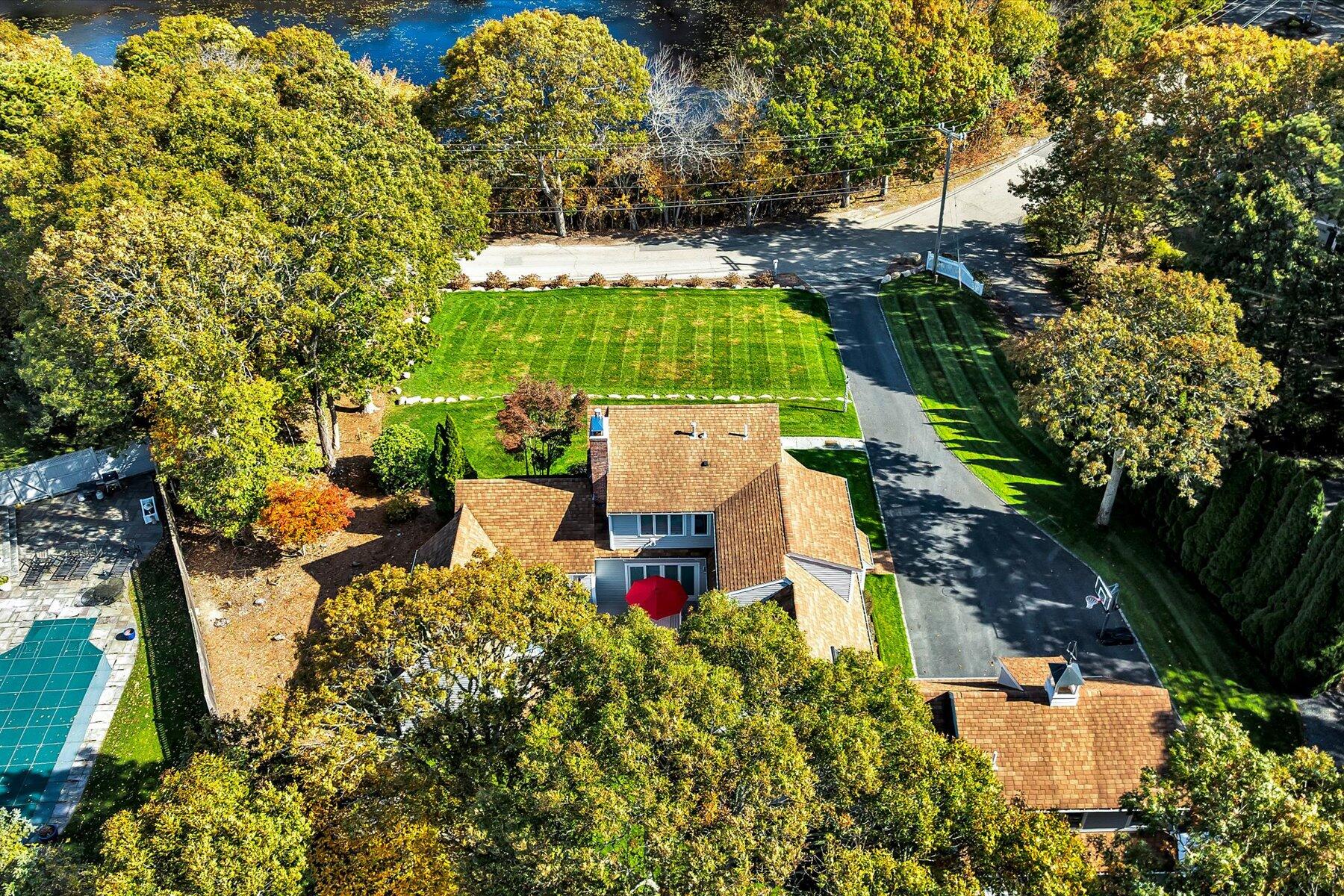 14 Ryder Road North Falmouth, MA 02556 - Photo 74 of 85 an aerial view of a house with a yard and large trees
