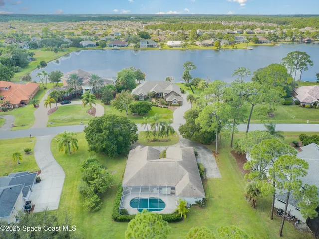 an aerial view of a house with a lake view
