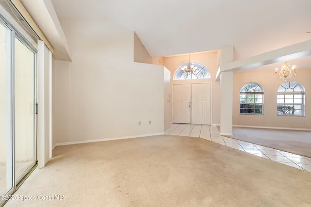an empty room with windows and cabinet