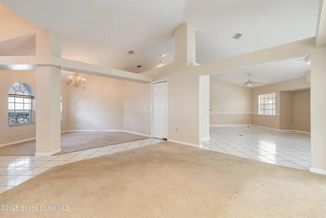 an empty room with windows and entrance