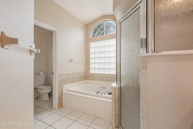 a bathroom with a tub and a window