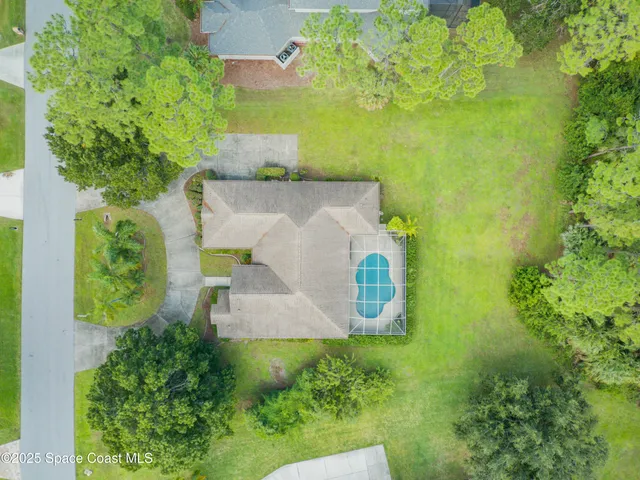 an aerial view of a house with a yard