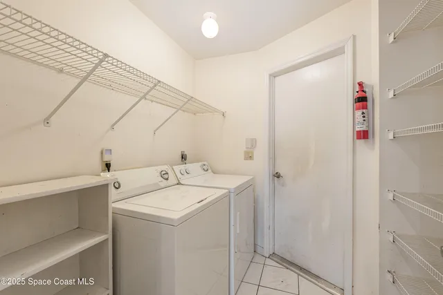 a dining room with furniture a chandelier and wooden floor