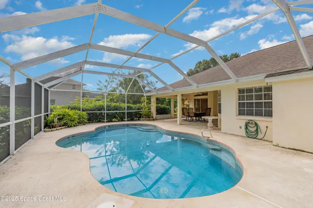 a view of a swimming pool with a patio