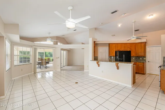 a large white kitchen with cabinets