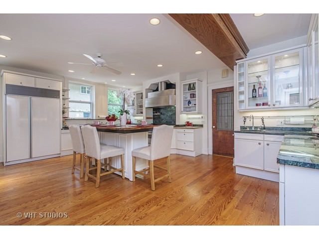 111 Broadway Avenue Wilmette, IL 60091 - Photo 11 of 25 a kitchen with stainless steel appliances kitchen island granite countertop a refrigerator and cabinets