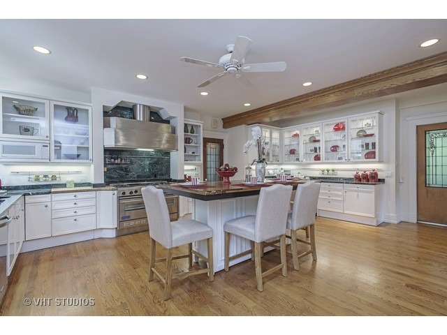 111 Broadway Avenue Wilmette, IL 60091 - Photo 12 of 25 a kitchen with a dining table chairs cabinets and stainless steel appliances