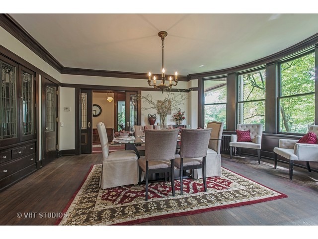 111 Broadway Avenue Wilmette, IL 60091 - Photo 8 of 25 a dining room with wooden floor a chandelier a rug and a chandelier