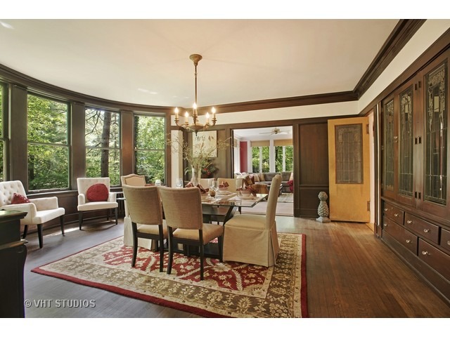 111 Broadway Avenue Wilmette, IL 60091 - Photo 9 of 25 a dining room with furniture a chandelier and wooden floor