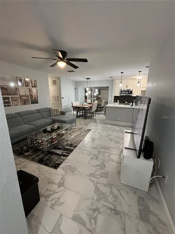 a kitchen with stainless steel appliances a stove a sink a oven cabinets and dining table