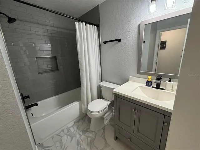 a bathroom with a bathtub and a toilet
