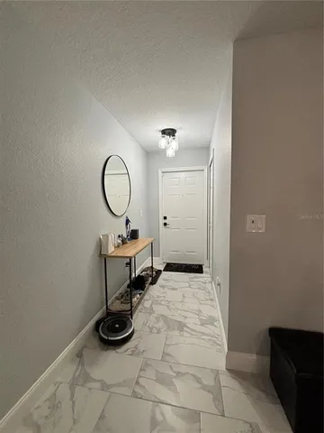 a living room with furniture and a ceiling fan