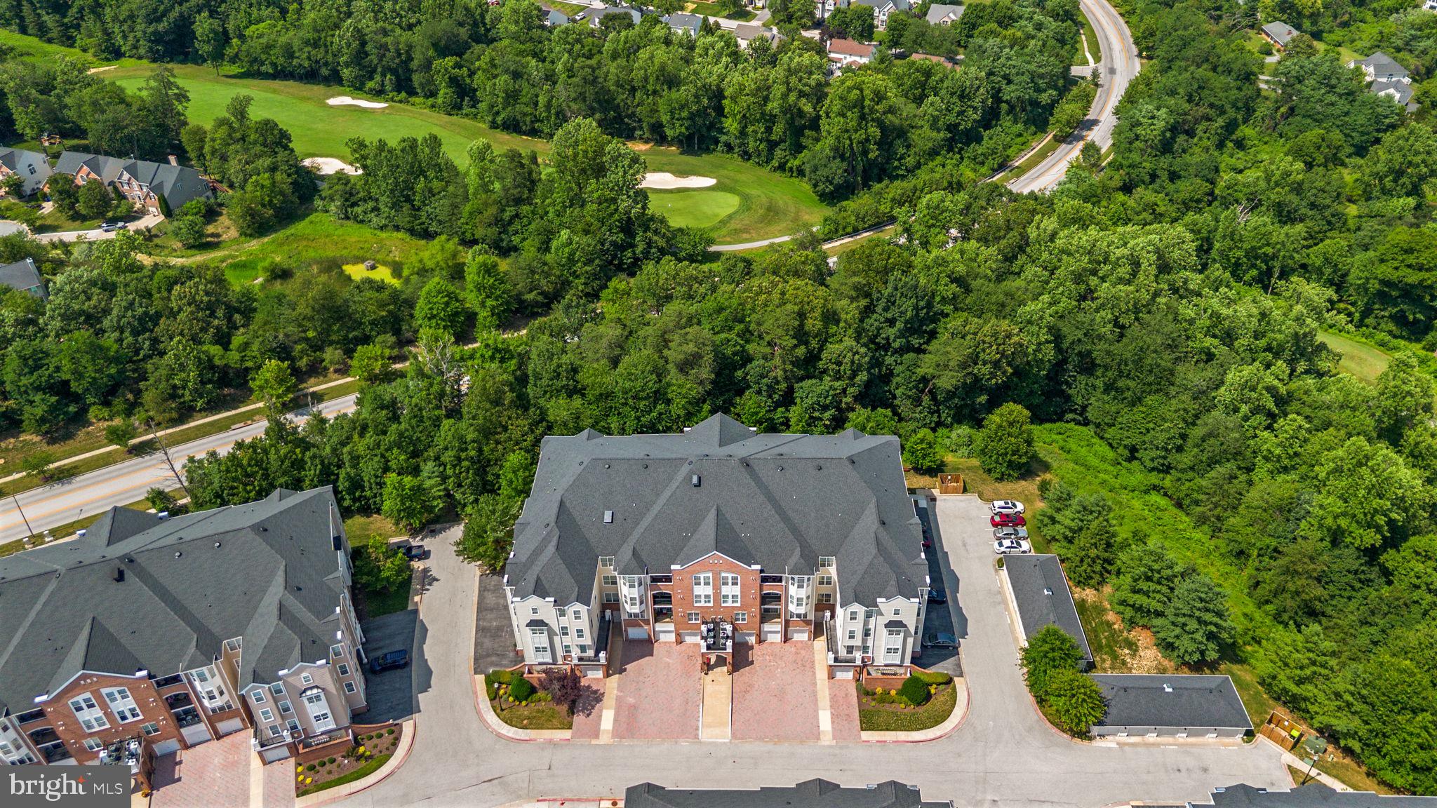 7315 Maplecrest Road, Unit 104 Elkridge, MD 21075 - Photo 2 of 58 an aerial view of a house with garden space and street view