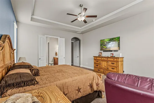 a bedroom with a large bed and a dresser