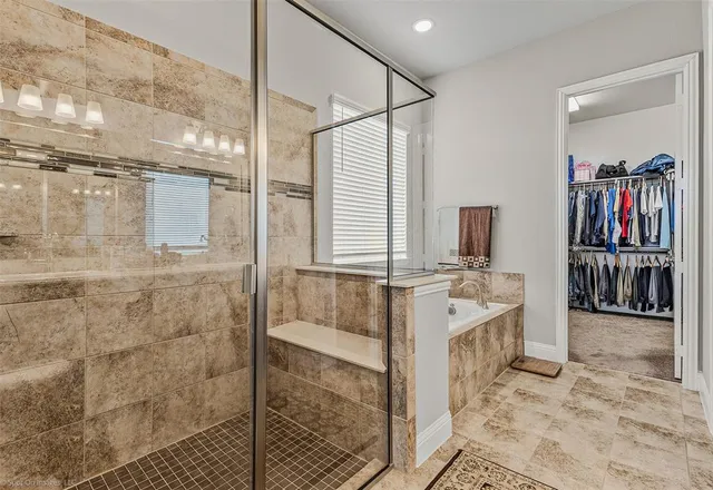 a bathroom with a tub sink and mirror