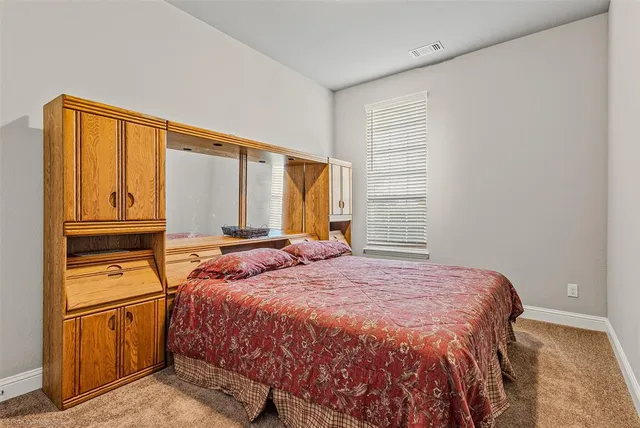 a bedroom with a bed next to a window