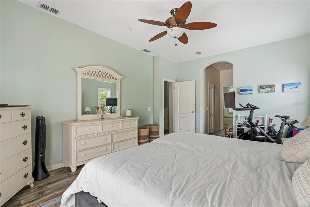 16748 Midsummer Lane Spring Hill, FL 34610 - Photo 37 of 52 a bedroom with a bed and a chandelier