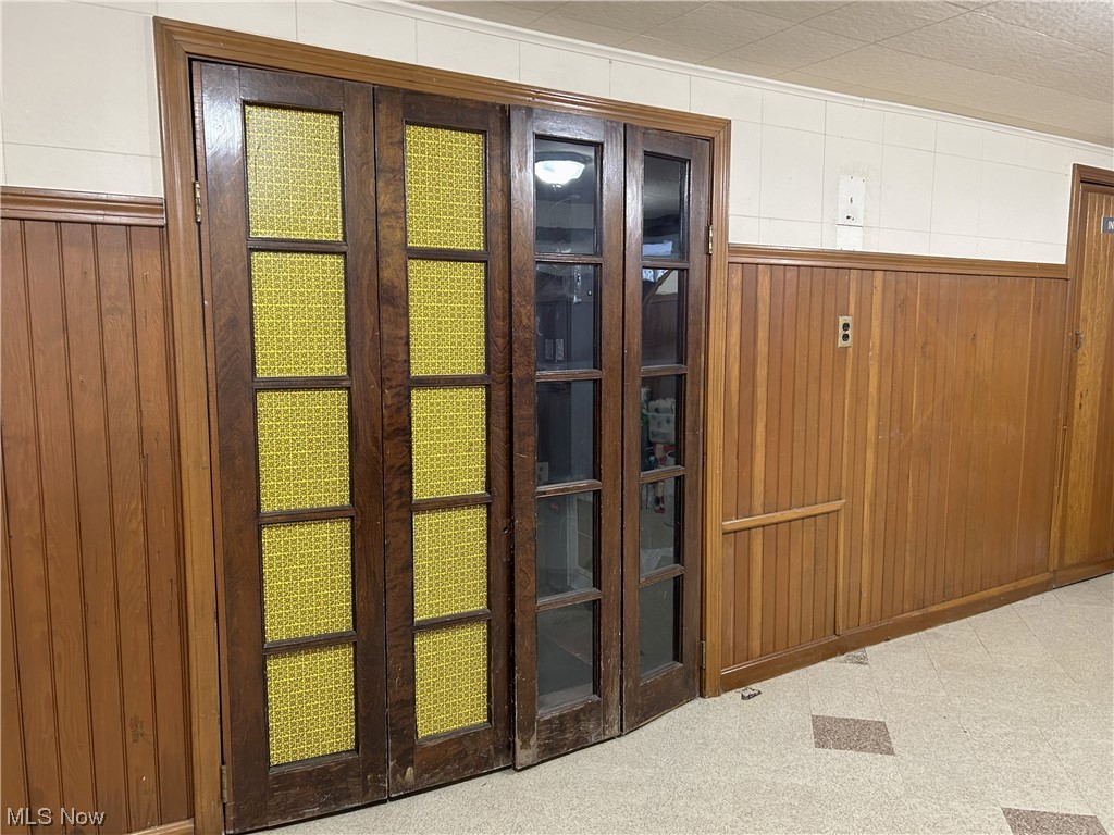 1748 Sunview Road Lyndhurst, OH 44124 - Photo 36 of 41 Recreation Room in lower level with wood paneling and French doors to the Laundry Room.