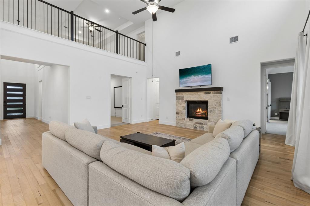 566 Broadleaf Way Haslet, TX 76052 - Photo 12 of 38 Expansive living area with high ceilings and wood-finish flooring
