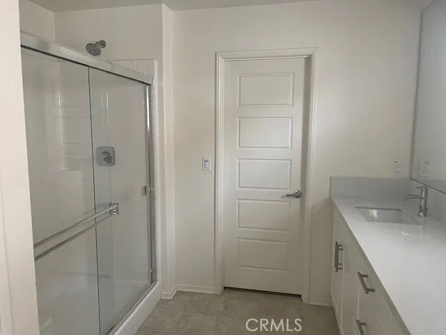 a bathroom with a shower and a sink