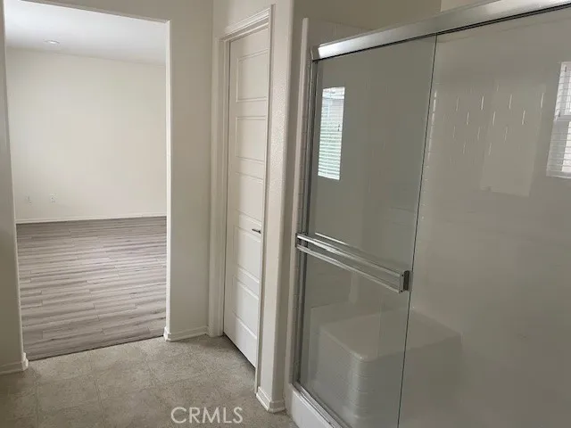 a bathroom with a glass shower door