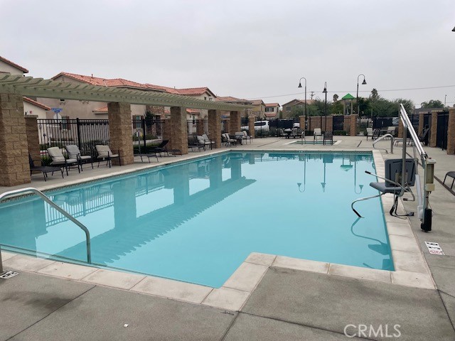 130 Citron Court Perris, CA 92571 - Photo 28 of 32 a view of a swimming pool with a chair and tables