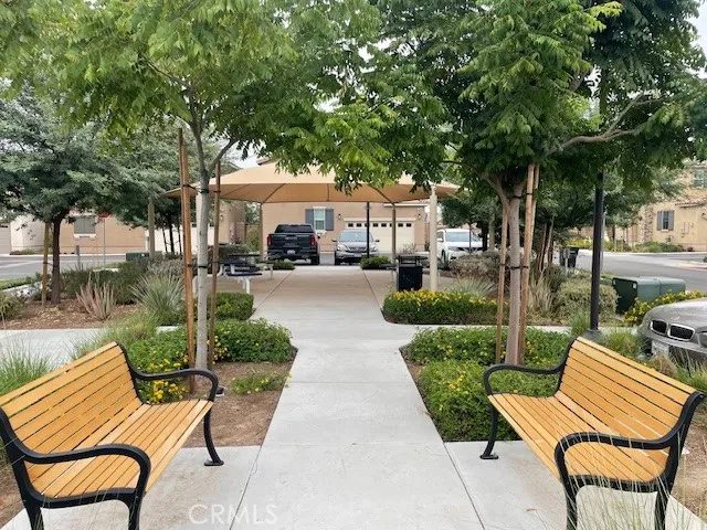 a view of a patio with table and chairs under an umbrella