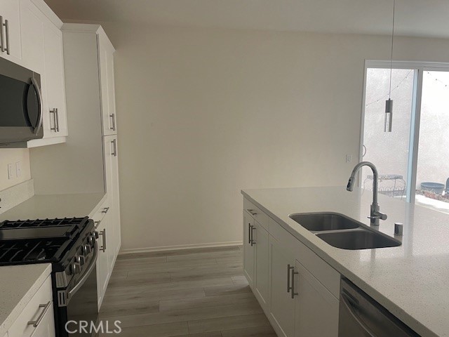130 Citron Court Perris, CA 92571 - Photo 5 of 32 a kitchen with stainless steel appliances granite countertop a sink and a stove