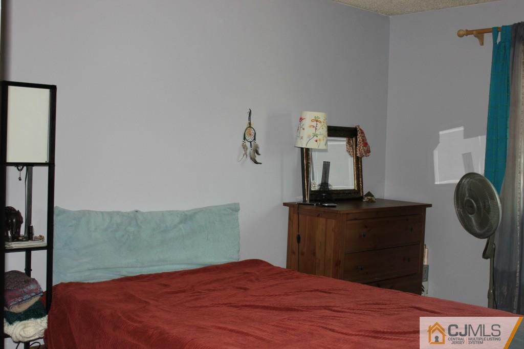 8007 Hana Road Edison, NJ 08817 - Photo 12 of 20 a bedroom with a bed and cabinets