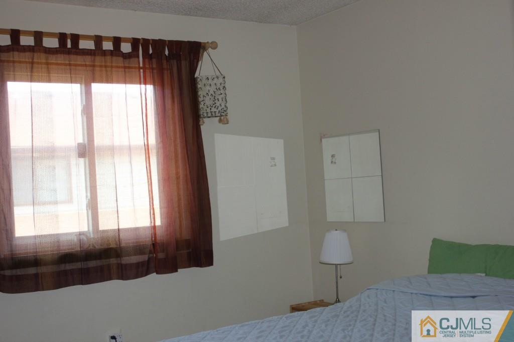 8007 Hana Road Edison, NJ 08817 - Photo 13 of 20 a bedroom with a bed and a window