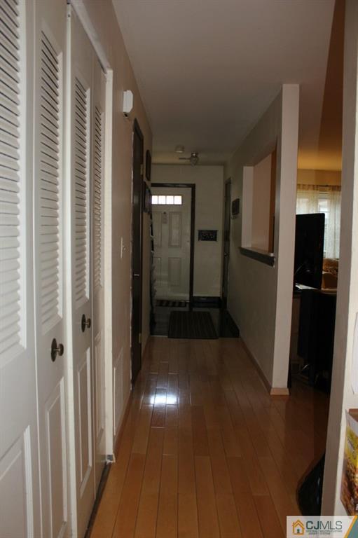 8007 Hana Road Edison, NJ 08817 - Photo 14 of 20 a view of a hallway with wooden floor and a living room