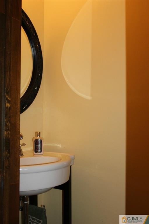 8007 Hana Road Edison, NJ 08817 - Photo 15 of 20 a bathroom with a sink and a mirror
