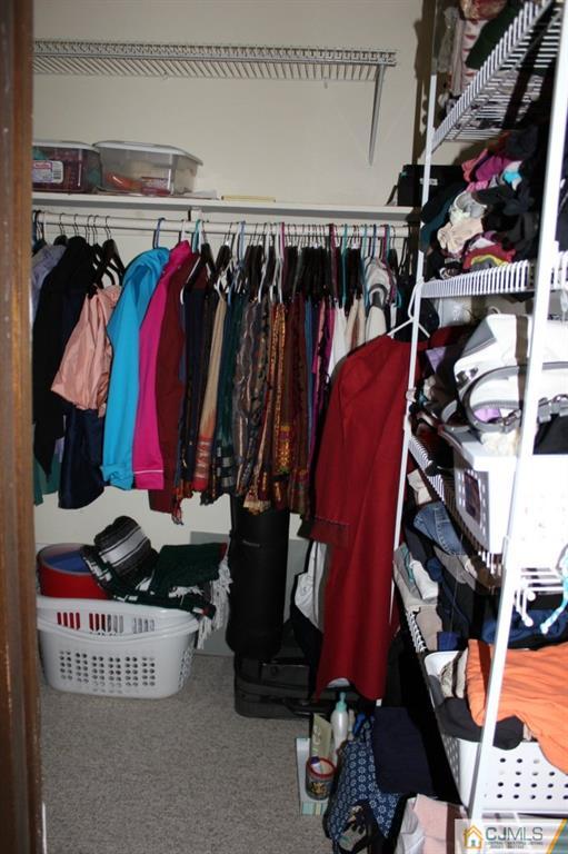 8007 Hana Road Edison, NJ 08817 - Photo 19 of 20 a view of walk in closet with clothes