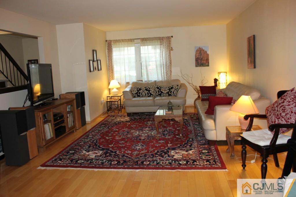 8007 Hana Road Edison, NJ 08817 - Photo 5 of 20 a living room with furniture and a flat screen tv