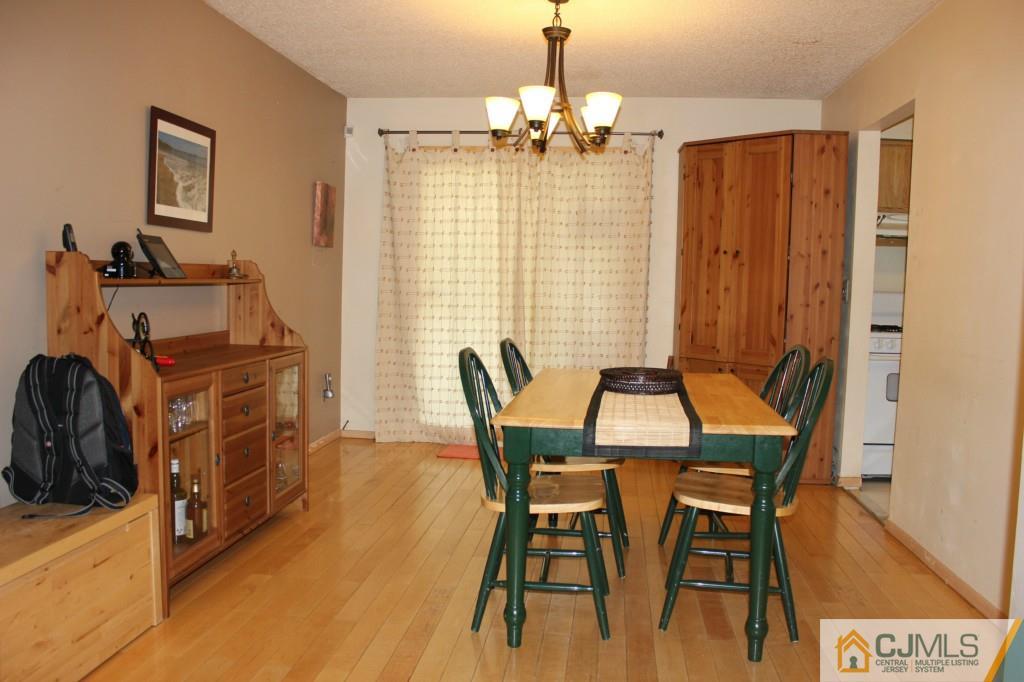 8007 Hana Road Edison, NJ 08817 - Photo 7 of 20 a view of a dining room with furniture and chandelier