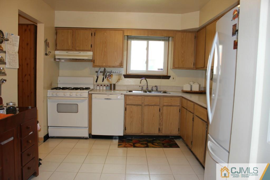 8007 Hana Road Edison, NJ 08817 - Photo 8 of 20 a utility room with cabinets washer and dryer