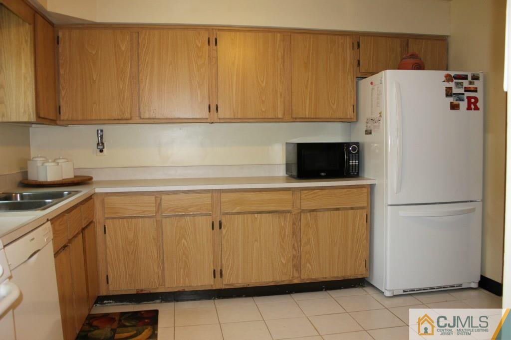 8007 Hana Road Edison, NJ 08817 - Photo 9 of 20 a white refrigerator freezer sitting in a kitchen