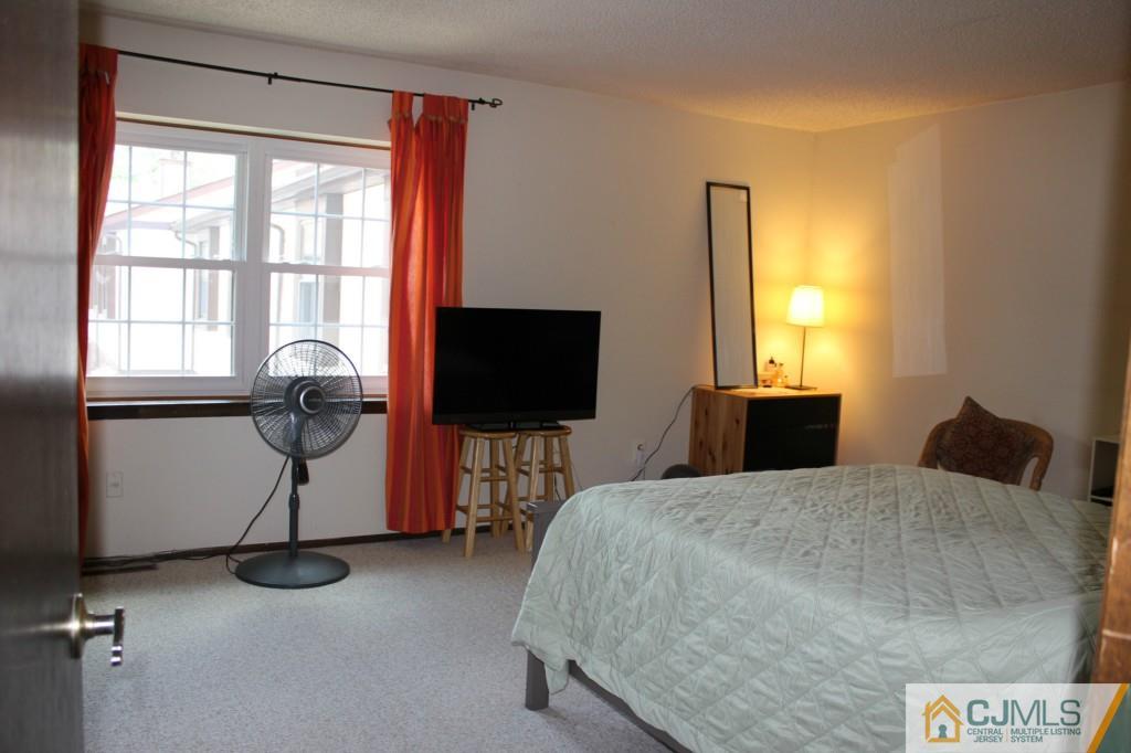 8007 Hana Road Edison, NJ 08817 - Photo 10 of 20 a bedroom with a bed and dresser