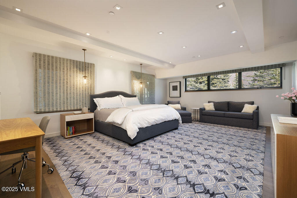 254 Beaver Dam Road Vail, CO 81657 - Photo 29 of 46 a spacious bedroom with a bed a couch and dresser