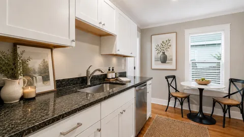 a kitchen with stainless steel appliances granite countertop a stove and a microwave