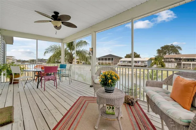 a living room with furniture dining table a chandelier and a floor to ceiling window