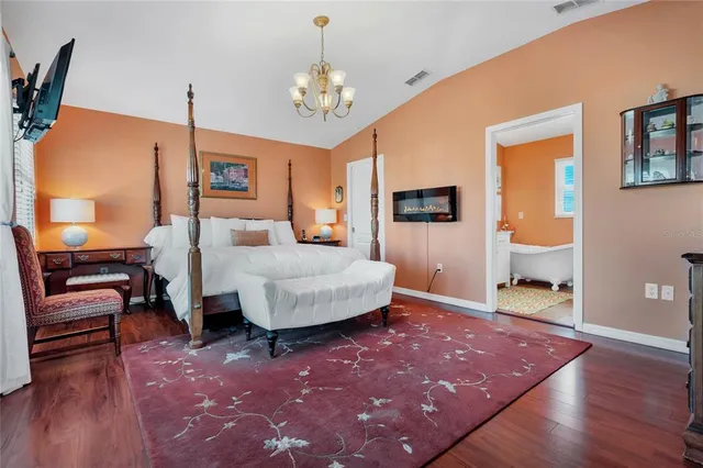 a bedroom with furniture and a chandelier
