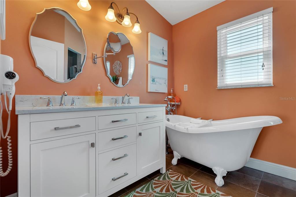 4049 Cobia Drive Hernando Beach, FL 34607 - Photo 23 of 40 a bathroom with a large mirror and sink