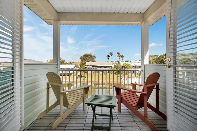 a view of a balcony with chair and wooden floor