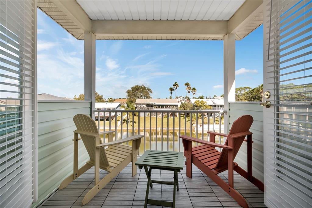 4049 Cobia Drive Hernando Beach, FL 34607 - Photo 24 of 40 a view of a balcony with chair and wooden floor