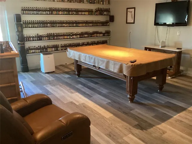 a bedroom with furniture and a flat screen tv