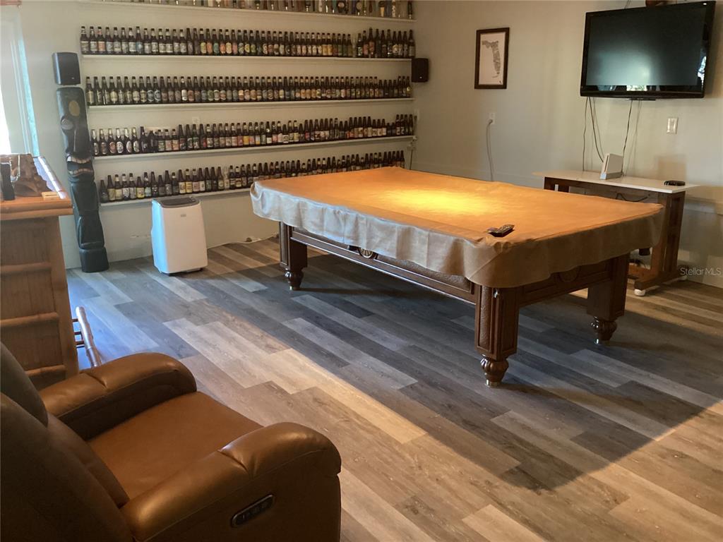 4049 Cobia Drive Hernando Beach, FL 34607 - Photo 27 of 40 a bedroom with furniture and a flat screen tv