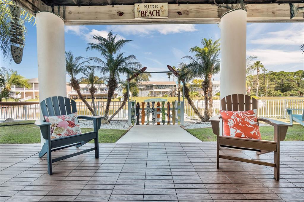 4049 Cobia Drive Hernando Beach, FL 34607 - Photo 33 of 40 a porch with seating space and benches