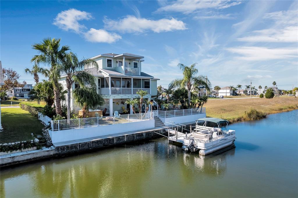 4049 Cobia Drive Hernando Beach, FL 34607 - Photo 35 of 40 a view of a swimming pool and lounge chair